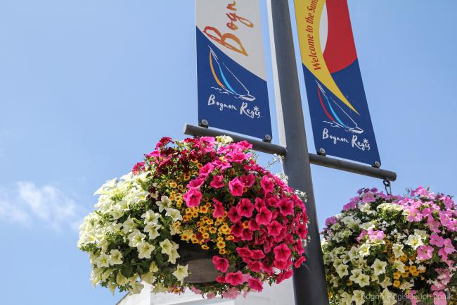 Baskets of flowers hanging on Bognor Regis sign in town