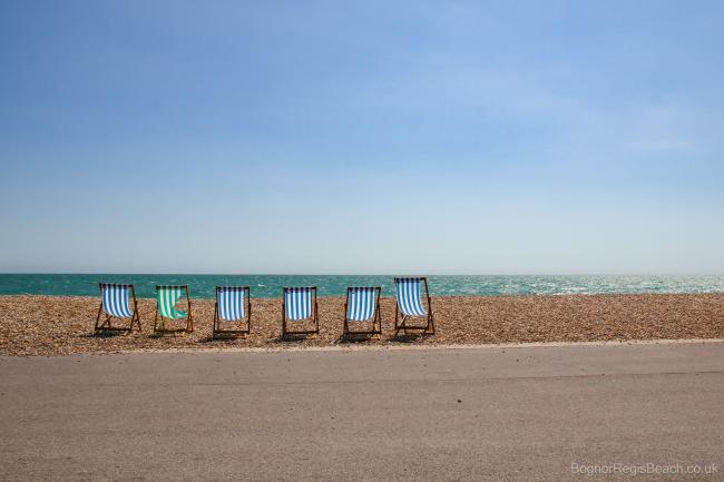 Row of 6 deckchairs on the beach at Bognor Regis summers day