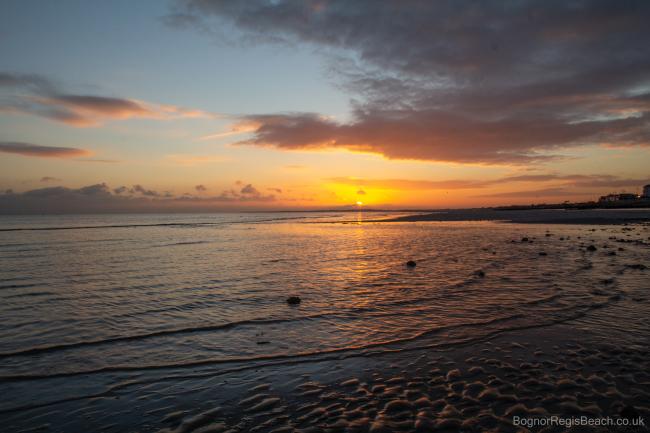 Sunset and wet sand at west beach Bognor Regis