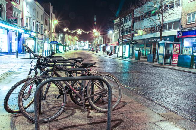 Bicycles in the high street Bognor Regis at night