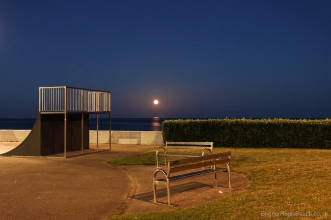 View of the skate park at night by the promenade with rising moon